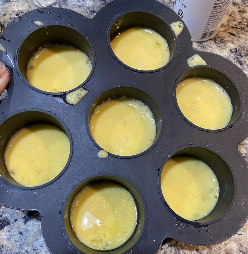 Filling a baking mold with egg bite batter