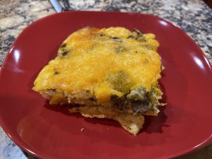 a square slice of breakfast egg casserole